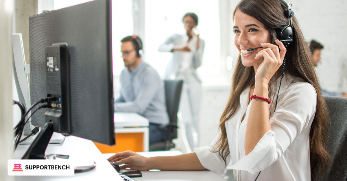 A woman wearing a headset works on her laptop, focusing on improving customer service consistency