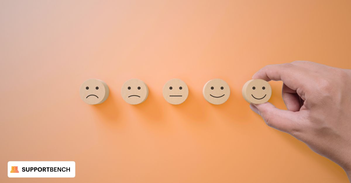 Wooden smiley faces held in a hand, illustrating the concept of Customer Effort Score