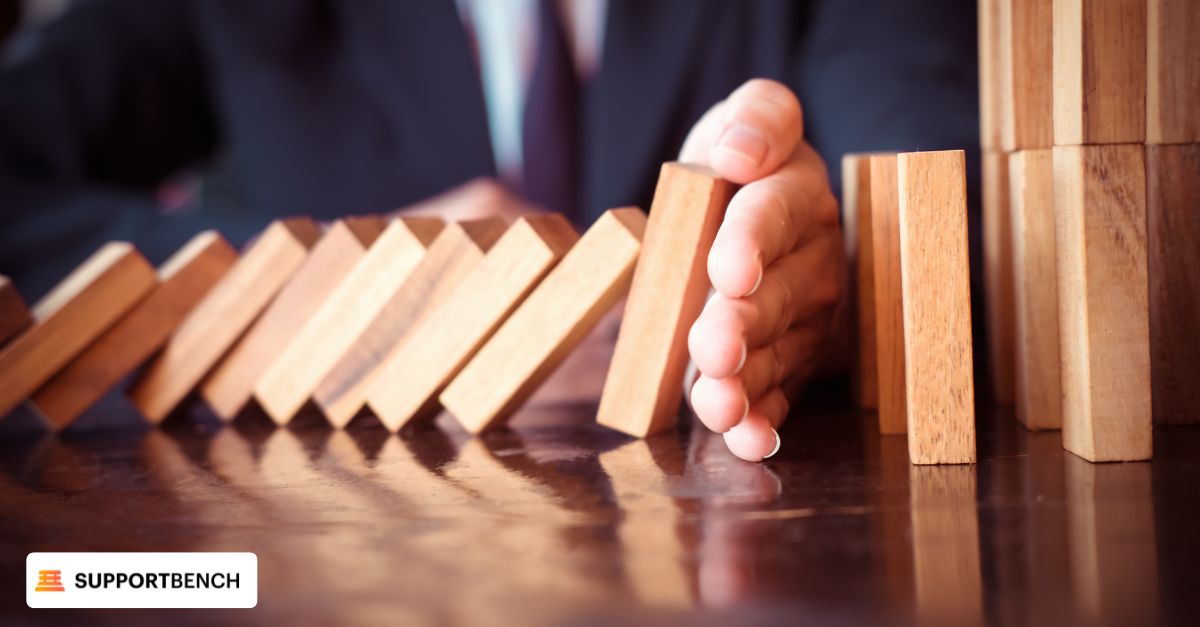 A person holds wooden blocks in front of a table, symbolizing challenges in Customer Lifecycle Management.