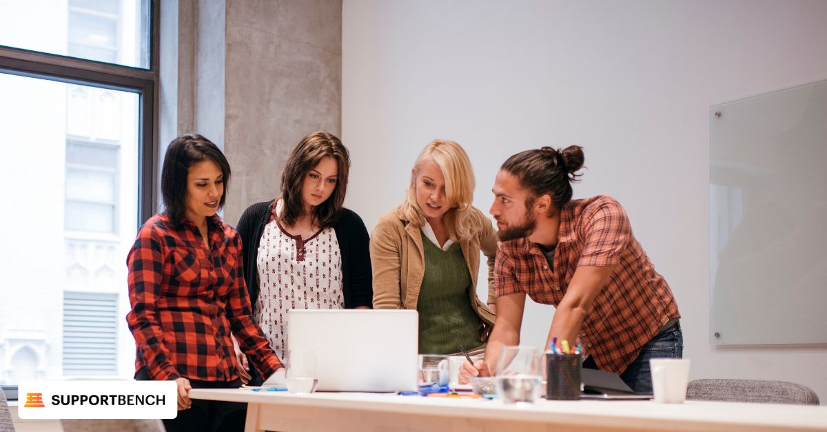 Meeting room scene with a group discussing Knowledge Management System issues