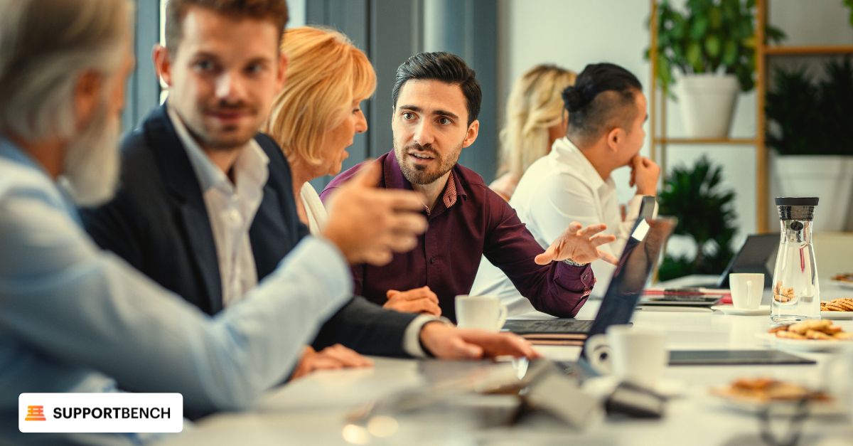 A diverse group of professionals engaged in an office meeting focused on building customer profiles using historical data
