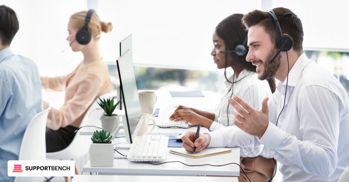 Agent resolving a support ticket on a computer while communicating with a client via