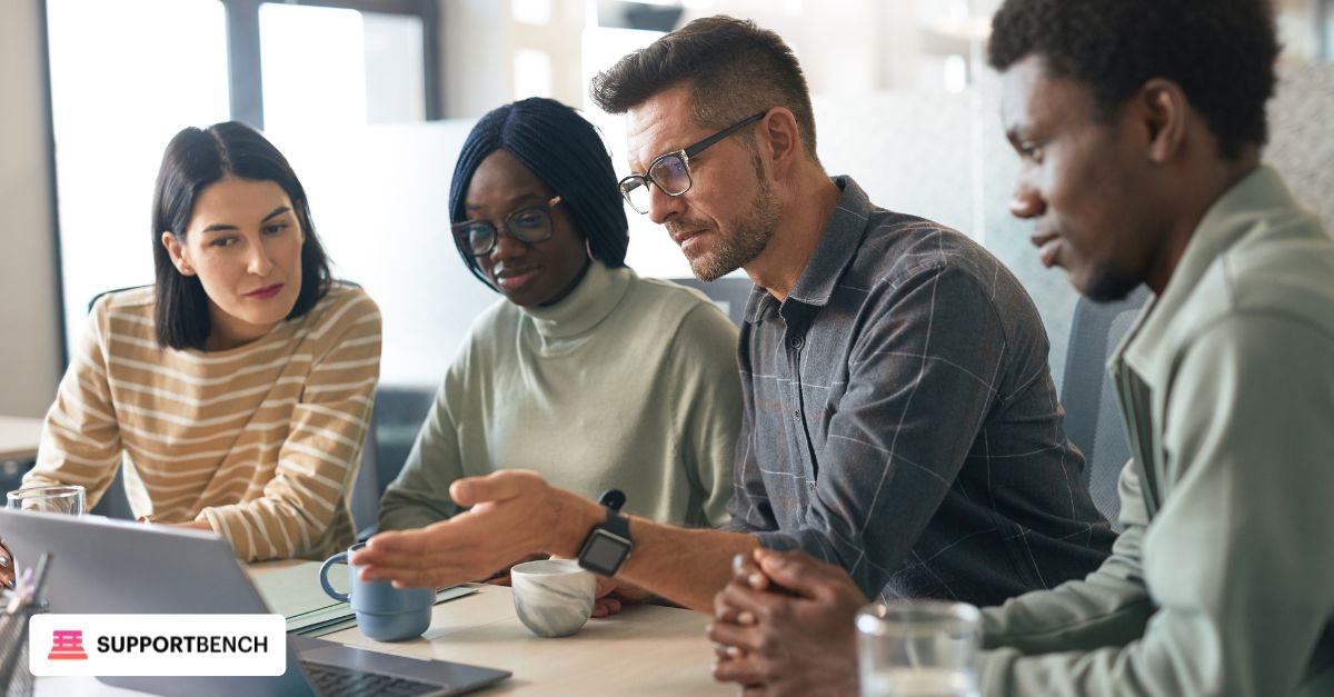 A group of IT professionals in a modern office configuring API integrations on multiple devices