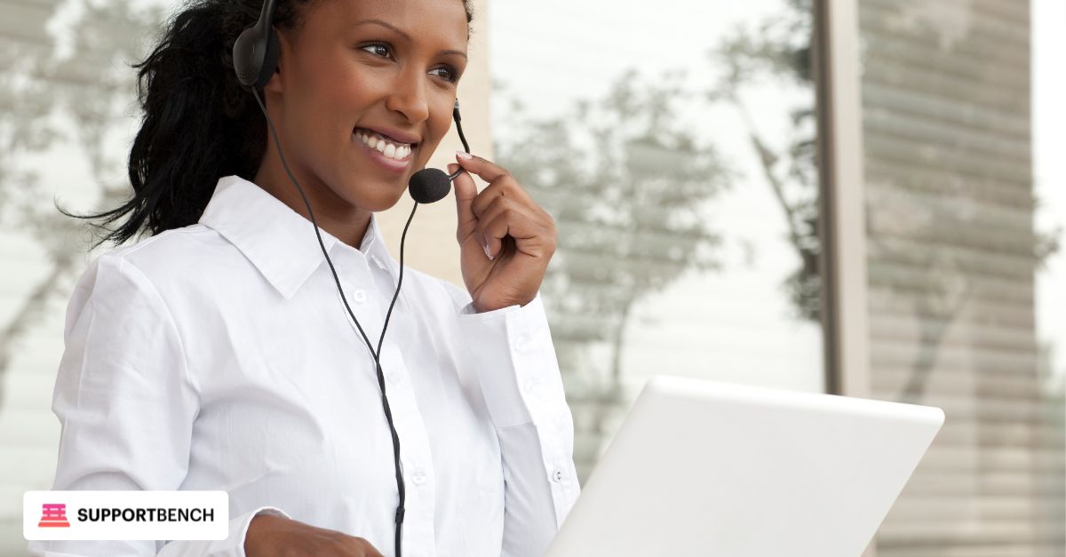 Helpdesk agent chatting with a client via live chat on one screen and email on another