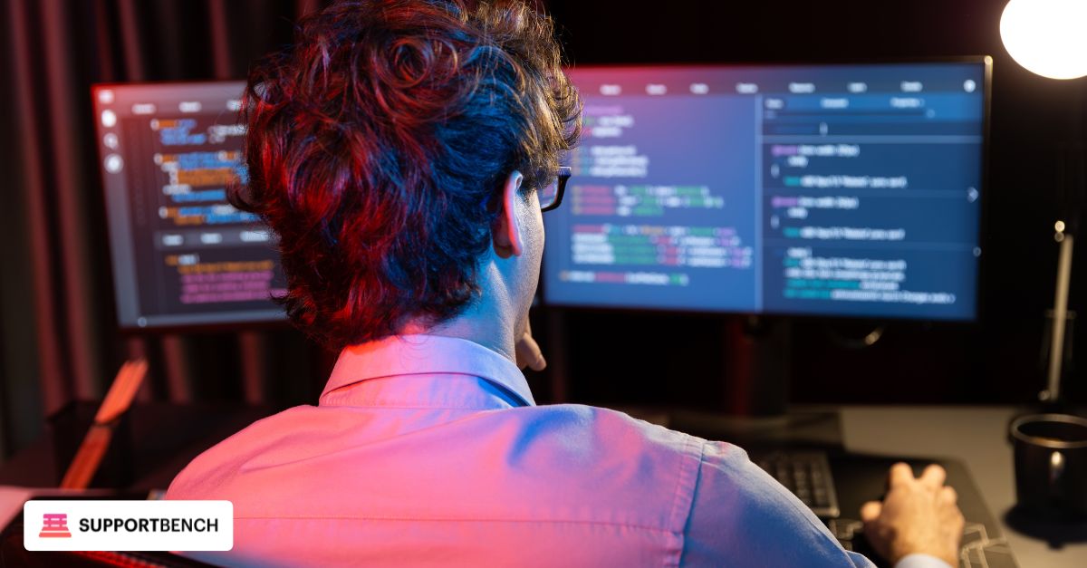 An IT technician sitting at a desk,