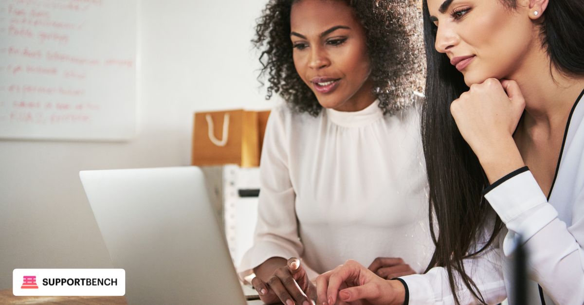 A business professional pointing at a printed agreement during a team onboarding session