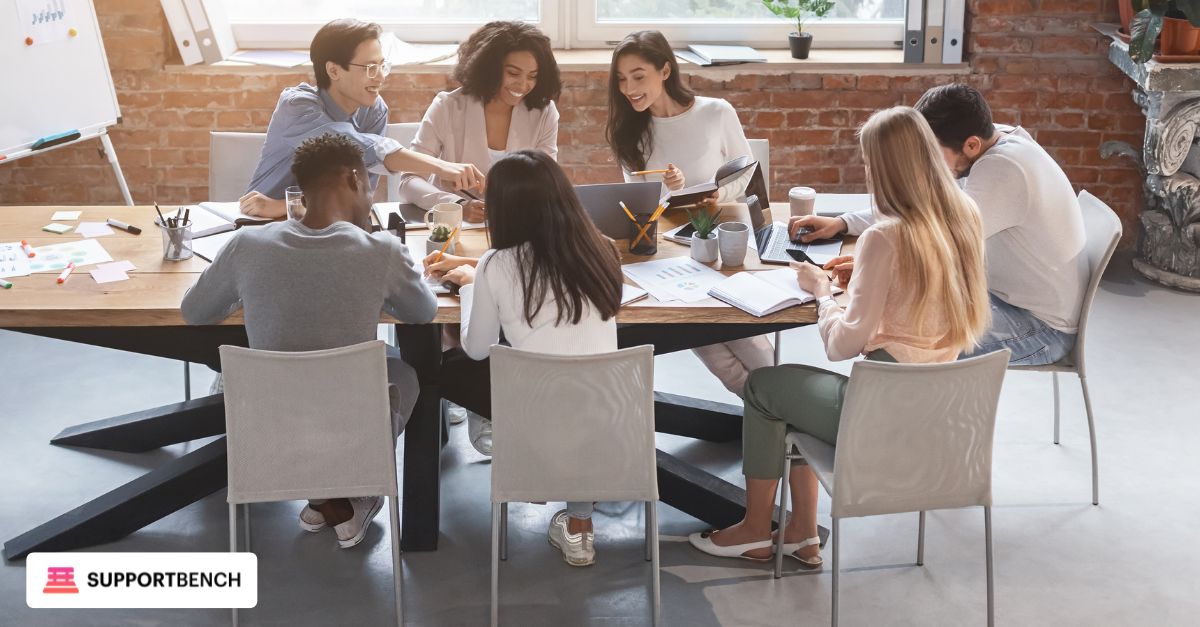 A diverse IT team gathered around a large table