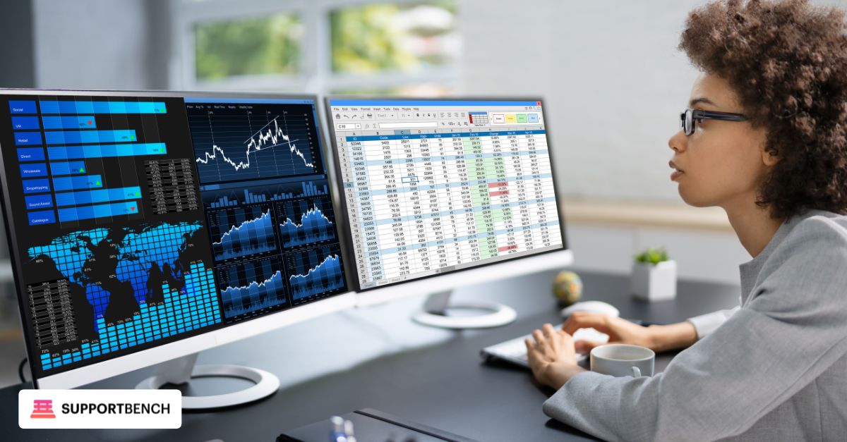An operations manager in a modern office space reviewing KPI dashboards on a tablet while discussing results with a senior IT team member.