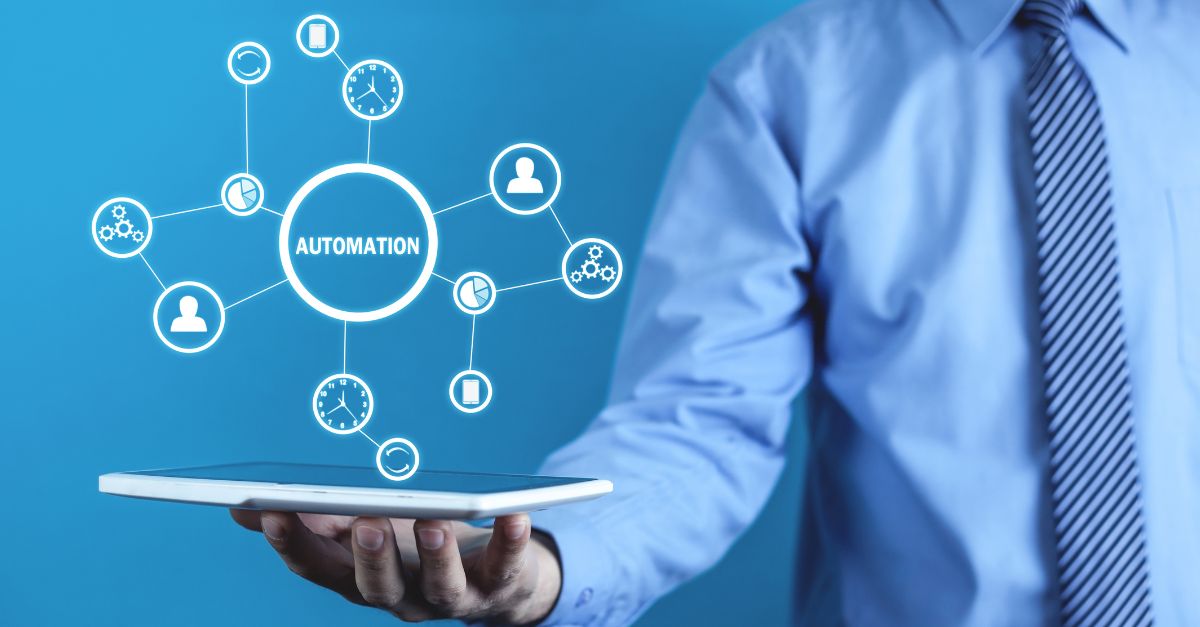 A person engaged in typing on a keyboard that displays various icons for content management automation.